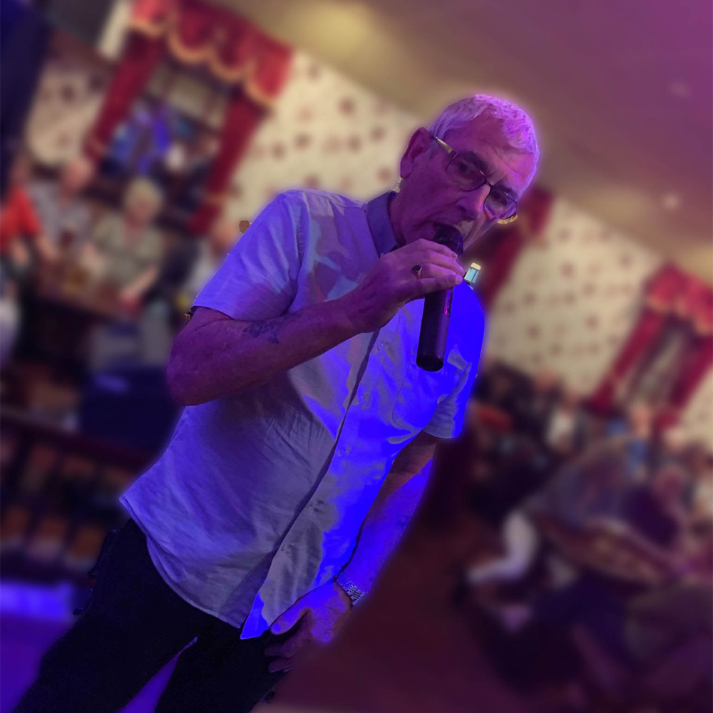 Guest singing into a wireless microphone at a karaoke night