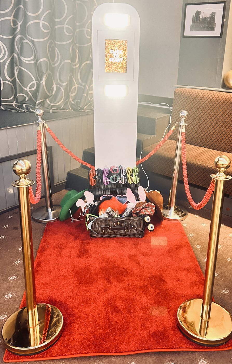 Modern white Selfie Pod with props, red carpet and rope barriers
