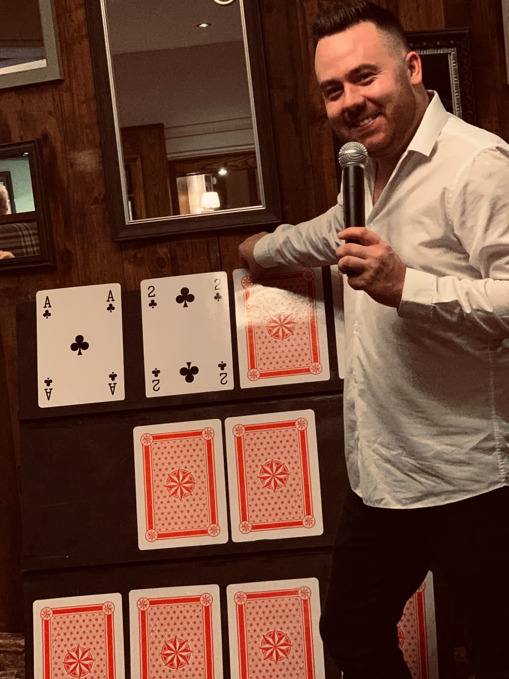 Andy hosting an interactive card game with a microphone