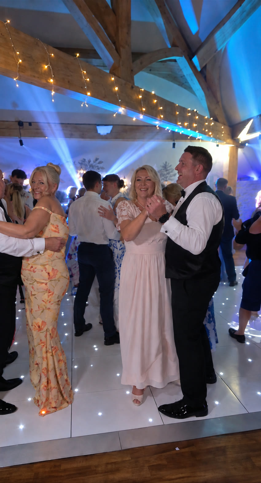 Wedding guests dancing together at a wedding reception